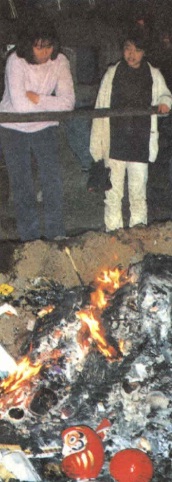 Daruma dolls being burned at a shrine during New Year