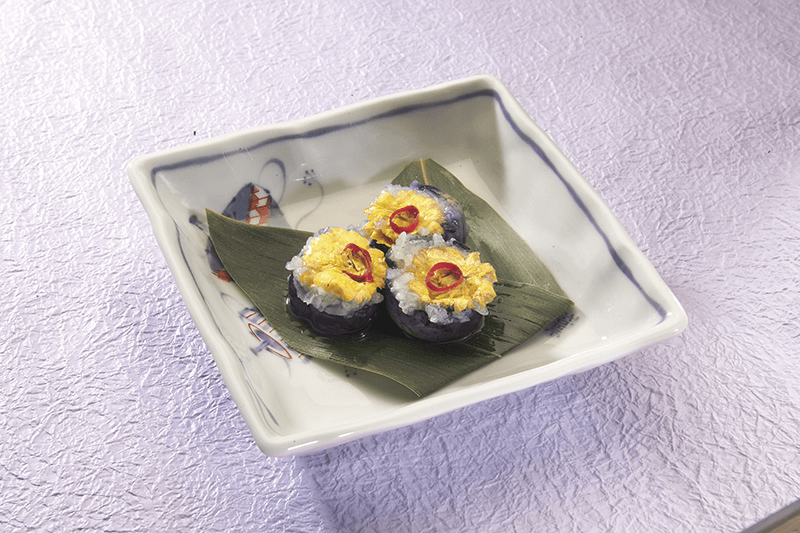 a plate with three pieces of hana zushi
