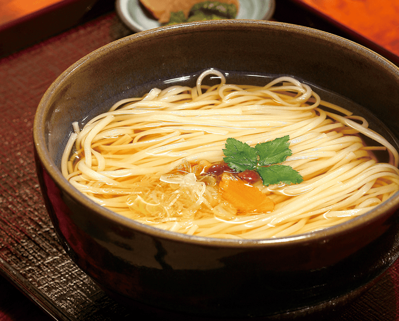 a bowl filled with akita inaniwa udon