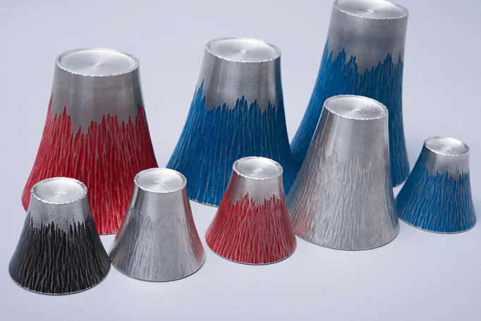 metal cups that are shaped like Mt. Fuji