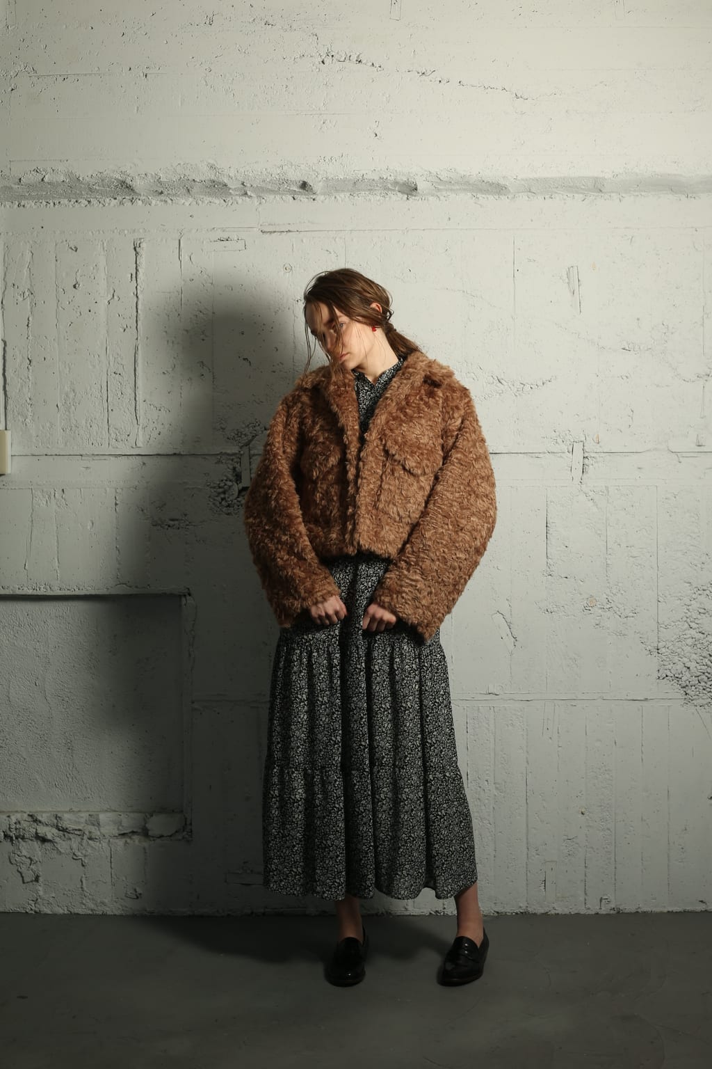 woman wearing dress and faux fur coat