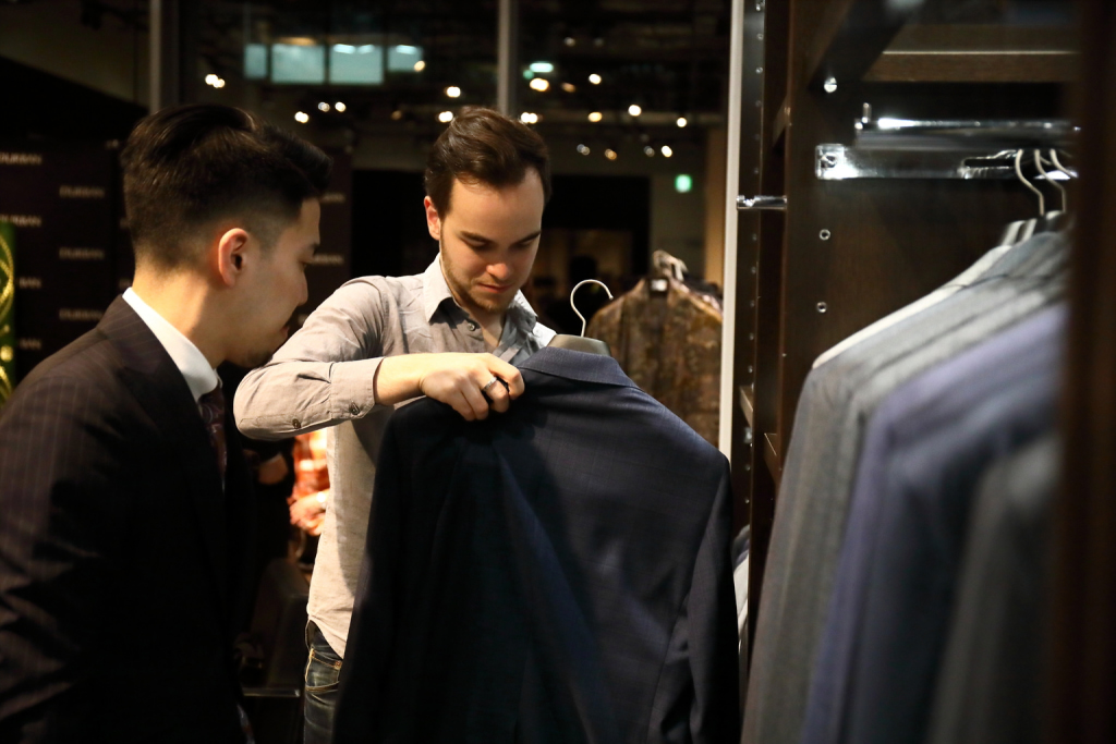 Customer looks at D'URBAN men's suits