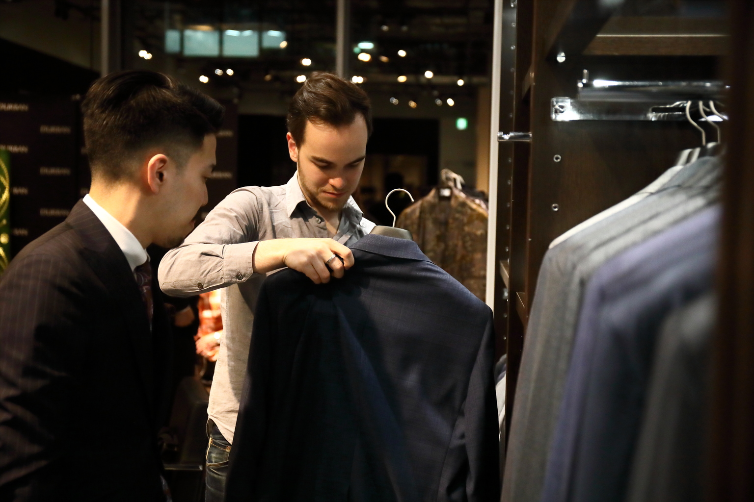 Customer looks at D'URBAN men's suits