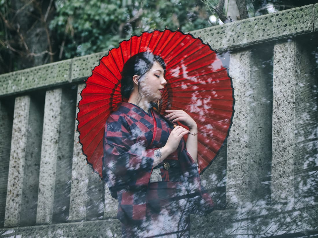 A woman in kimono holding parasol in Tokyo