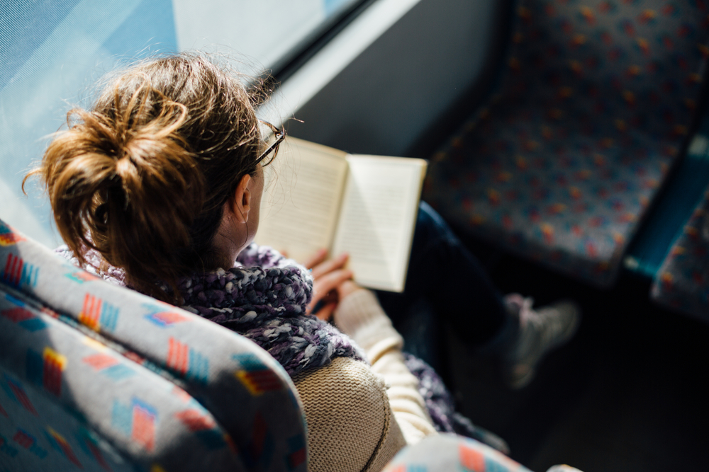 a woman reading in the train