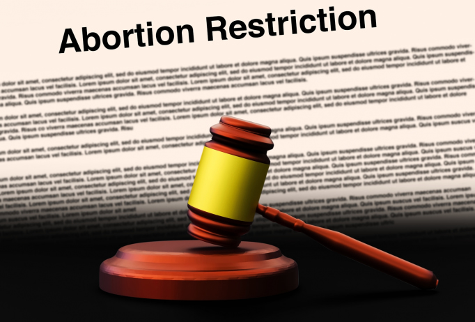 gavel banging down over 'abortion restriction' background
